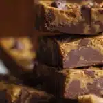 Delicious homemade peanut butter chocolate bars stacked on a plate.