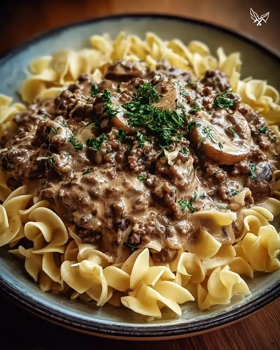 A hearty plate of ground beef stroganoff topped with fresh parsley.