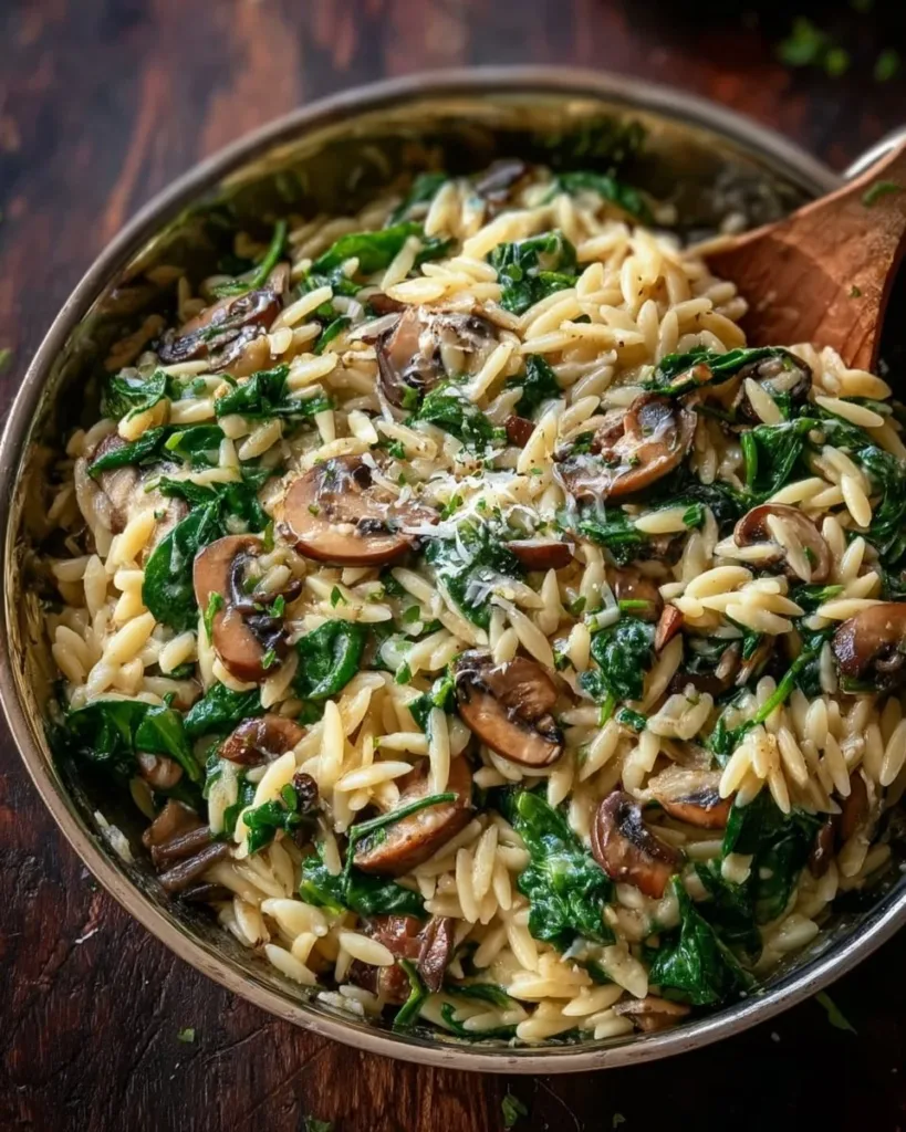 Creamy garlic butter orzo with mushrooms and spinach served in a bowl