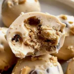 Frozen Greek yogurt peanut butter bites topped with chocolate and nuts