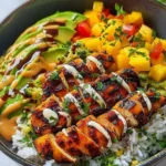 Grilled maple sriracha chicken bites served with a side of dipping sauce.