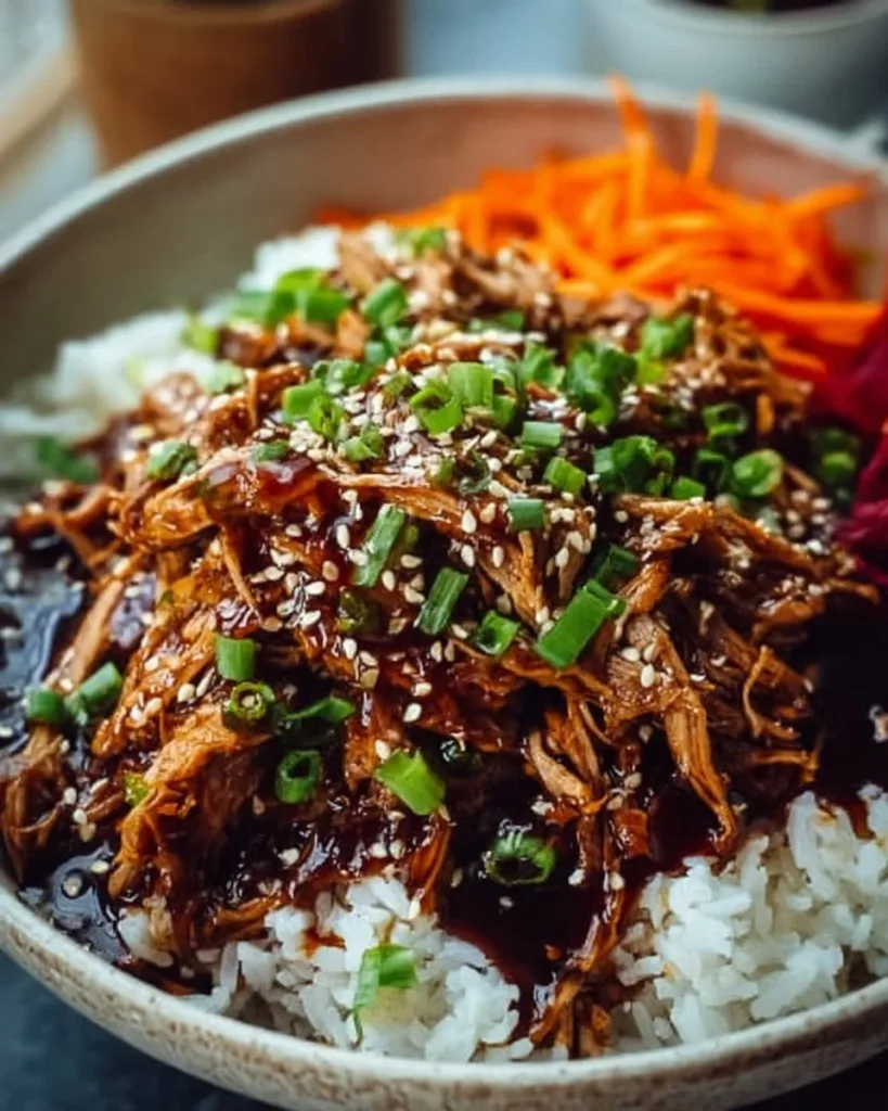 Delicious slow cooker Asian pulled pork served with fresh vegetables