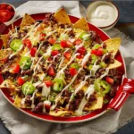 Delicious Taco Beef Nachos topped with cheese and fresh ingredients