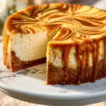 Slice of easy pumpkin swirl cheesecake with a creamy topping
