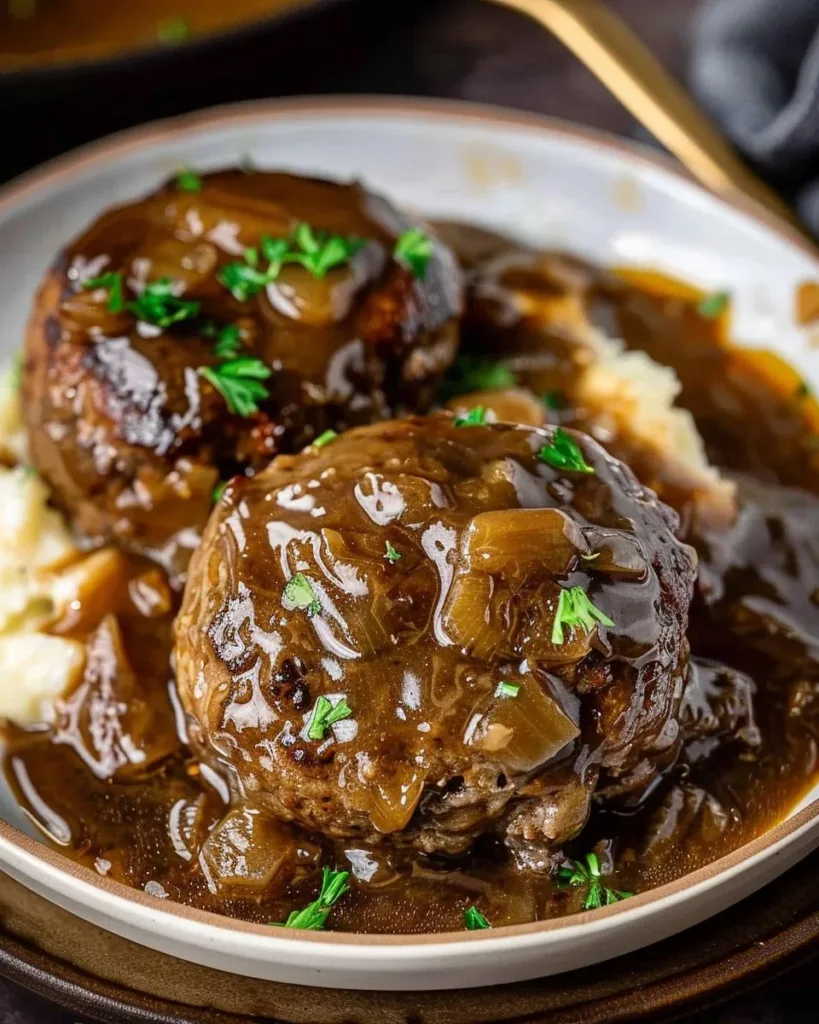 Delicious slow cooker Salisbury steaks served on a plate with mashed potatoes