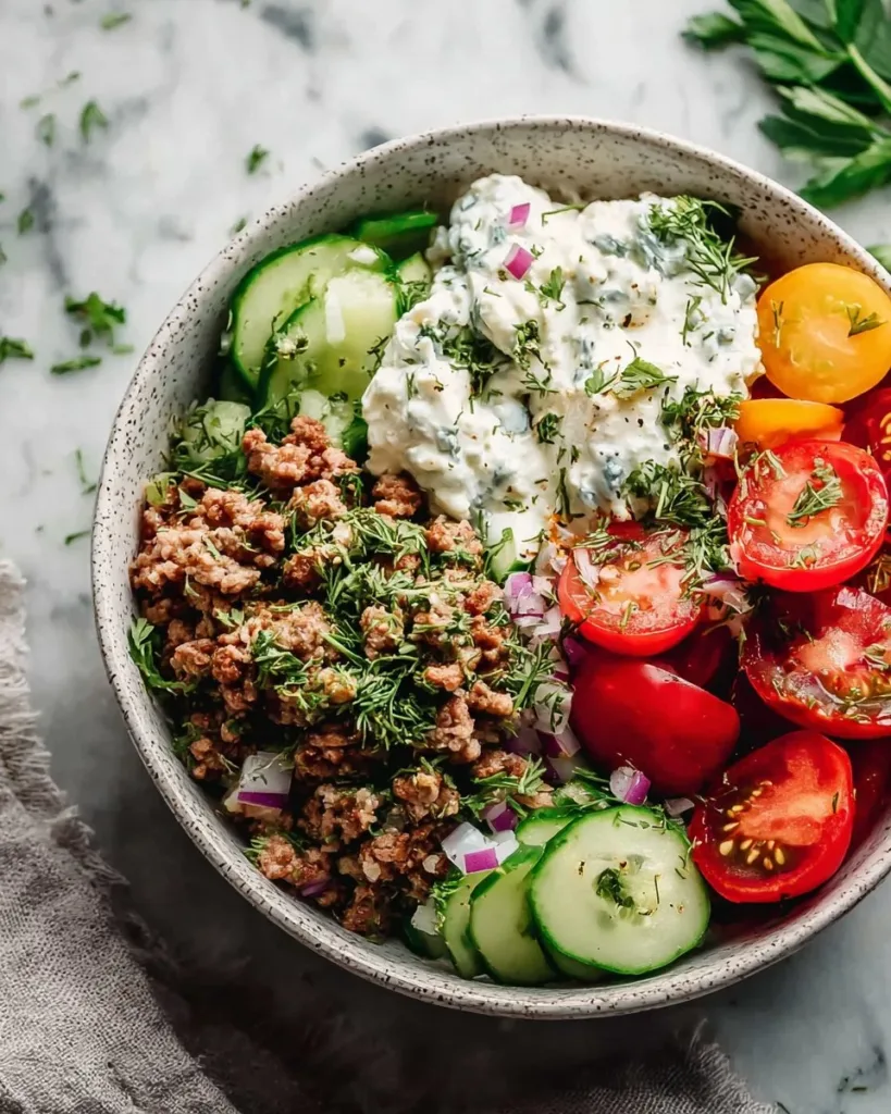 Mediterranean Ground Turkey Bowl topped with fresh vegetables and herbs