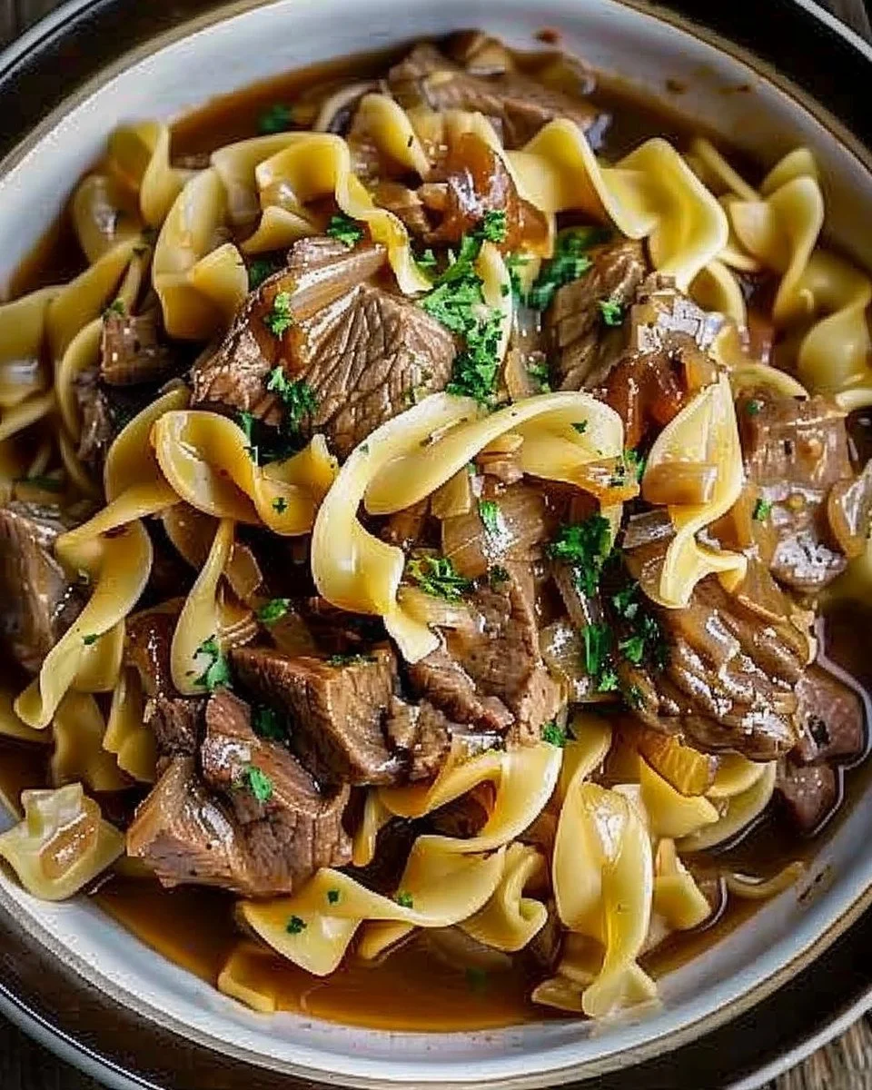 Delicious slow cooker beef and noodles served in a bowl with herbs