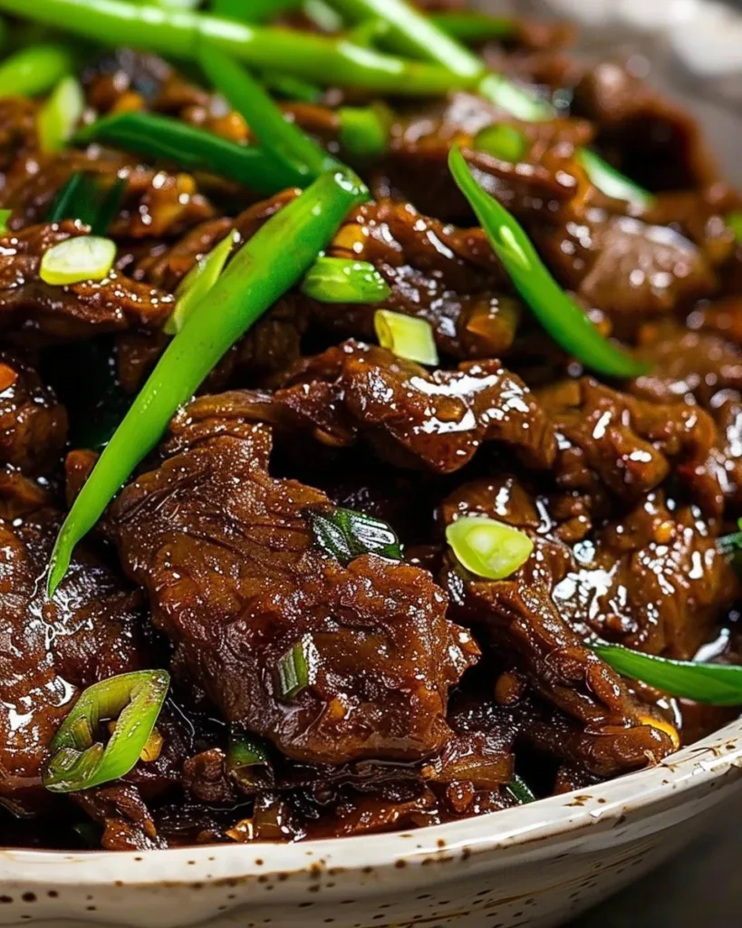 Delicious Slow Cooker Mongolian Beef served with rice and vegetables