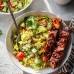 BBQ chicken skewer salad with grilled chicken, fresh greens, and barbecue sauce